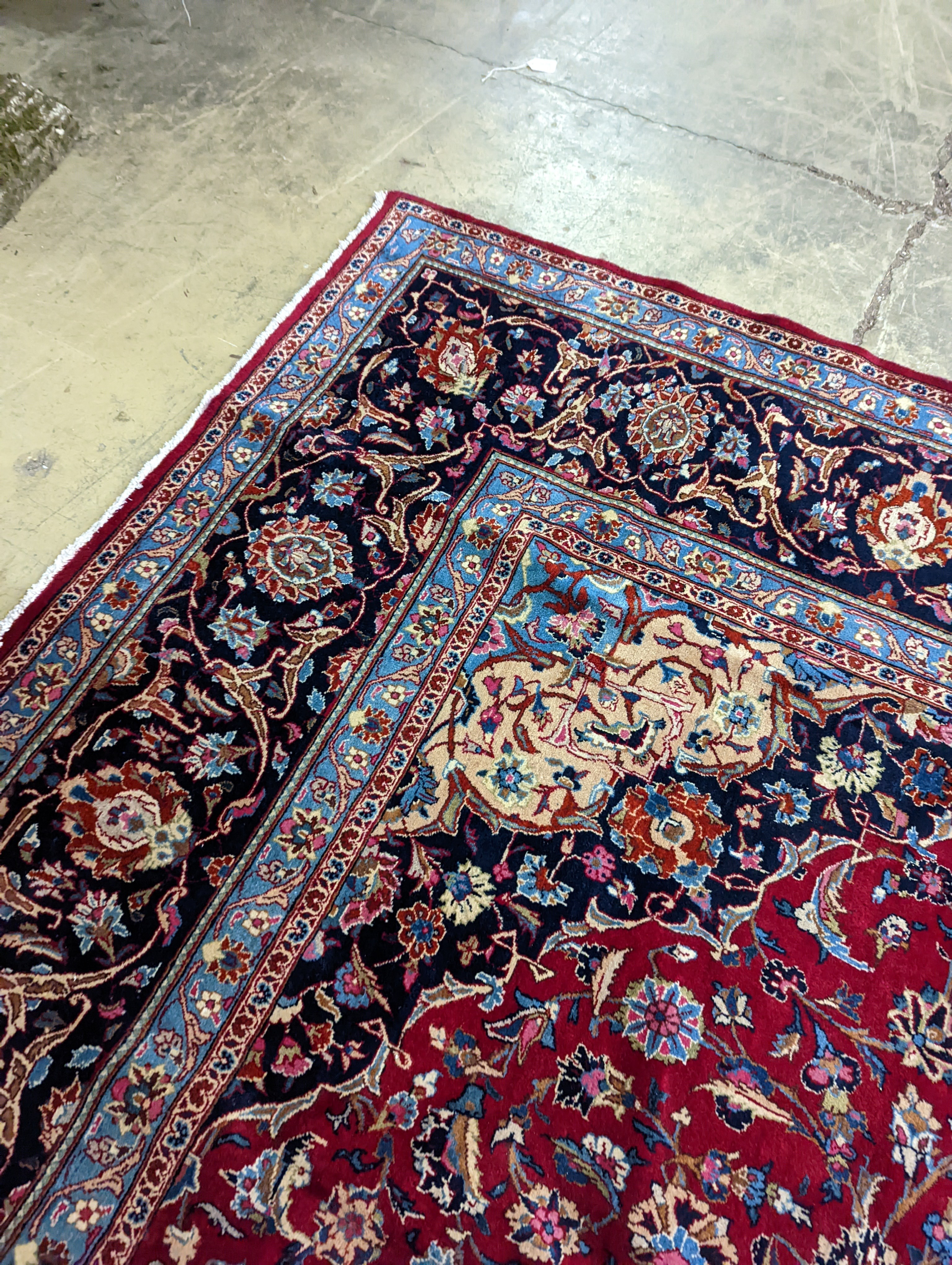 A Kashan burgundy ground carpet, 380 x 300cm